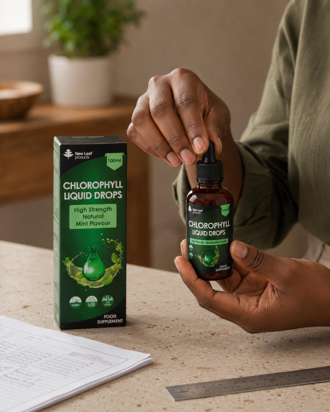 Hands checking the seal on a New Leaf Chlorophyll Liquid Drops bottle beside its original carton